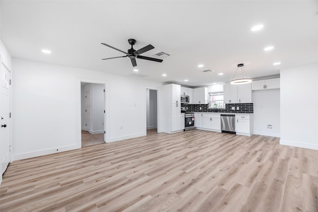 unfurnished living room with ceiling fan, sink, and light hardwood / wood-style floors