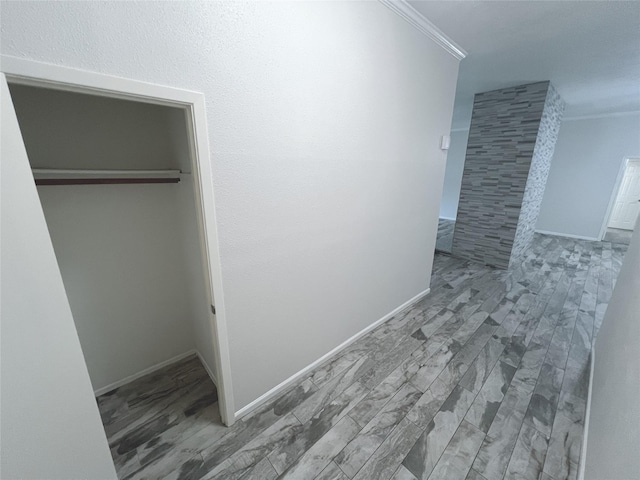 hallway featuring ornamental molding and hardwood / wood-style floors