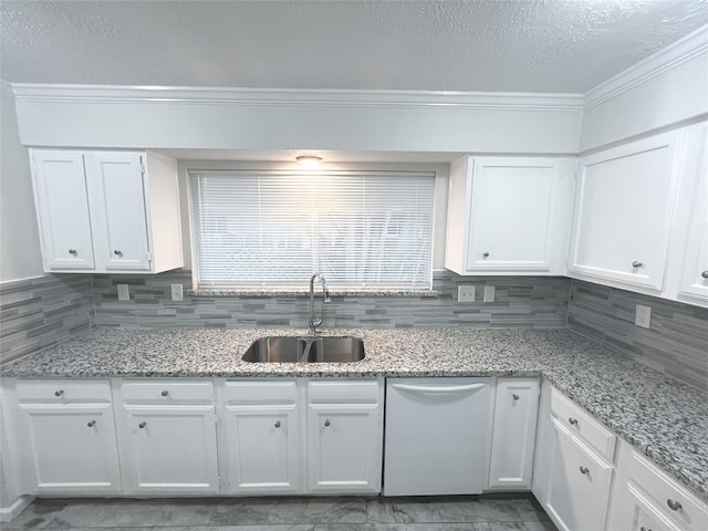 kitchen with tasteful backsplash, dishwasher, sink, white cabinets, and light stone counters