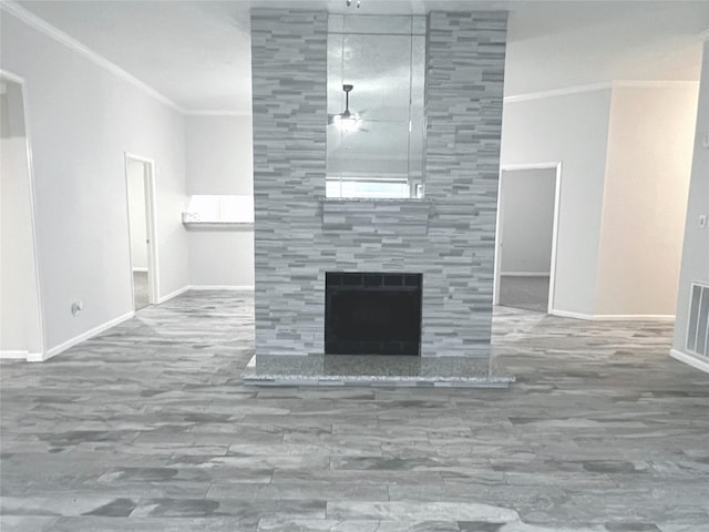 unfurnished living room with crown molding and a tile fireplace