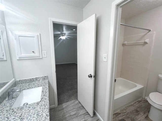 full bathroom with vanity, a textured ceiling, toilet, and shower / bath combination