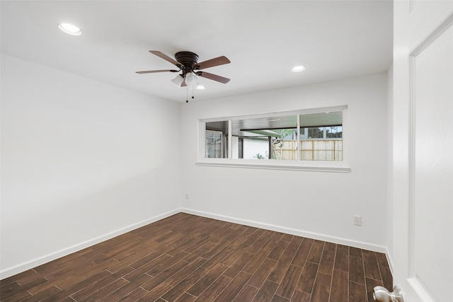 unfurnished room with ceiling fan and dark hardwood / wood-style flooring