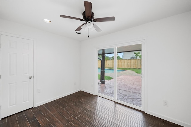 empty room with dark hardwood / wood-style floors and ceiling fan