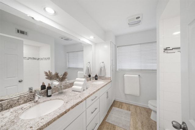 bathroom featuring vanity, hardwood / wood-style floors, and toilet