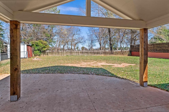 view of yard with a storage shed and a patio