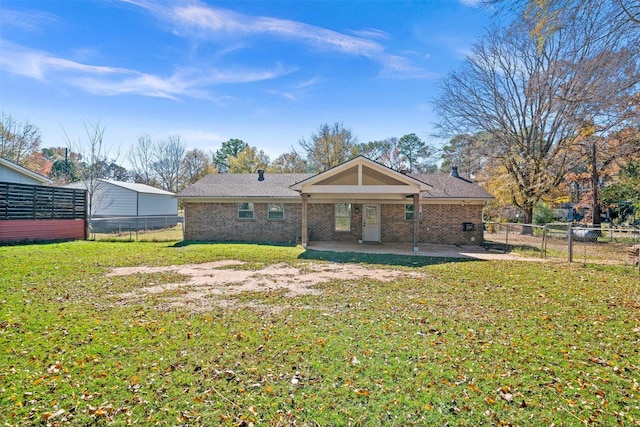 back of house featuring a patio area and a lawn