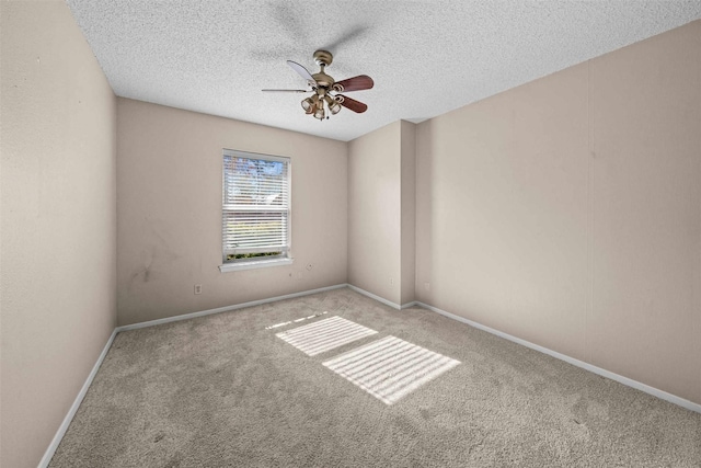 carpeted empty room with ceiling fan and a textured ceiling