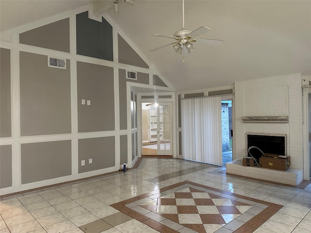 unfurnished living room featuring a fireplace, high vaulted ceiling, and ceiling fan