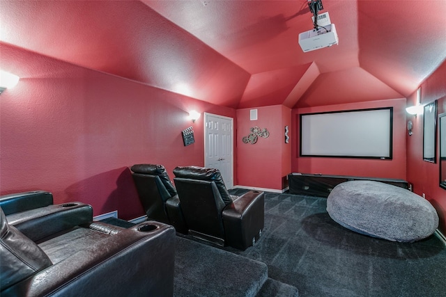 cinema with dark colored carpet and lofted ceiling