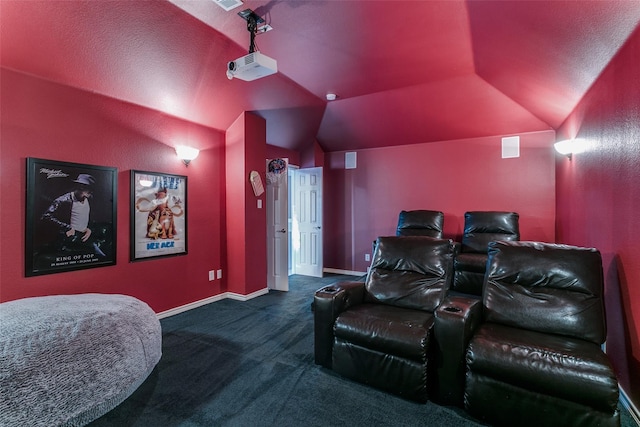 carpeted cinema room featuring vaulted ceiling