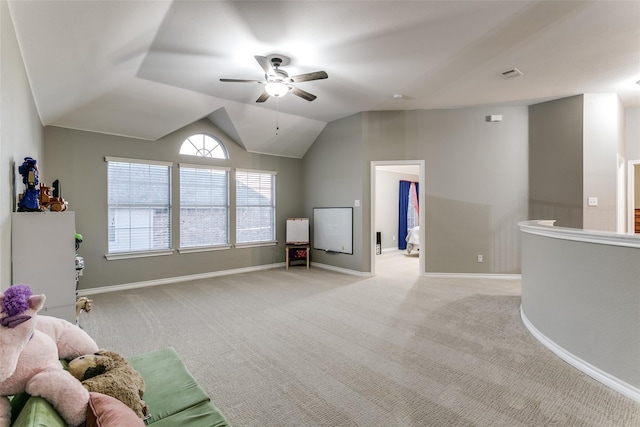 sitting room featuring ceiling fan, light colored carpet, and lofted ceiling