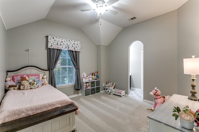 bedroom with ceiling fan, lofted ceiling, and light carpet