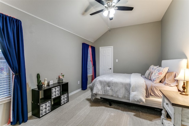 carpeted bedroom with vaulted ceiling and ceiling fan