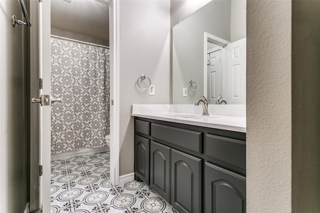 bathroom featuring vanity, tile patterned floors, and toilet