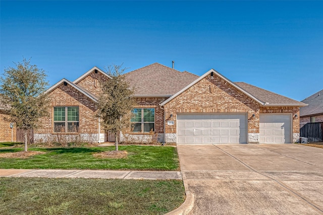 view of front of house with a garage and a front lawn