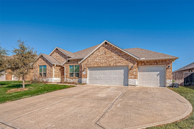 view of front of house with a garage and a front lawn