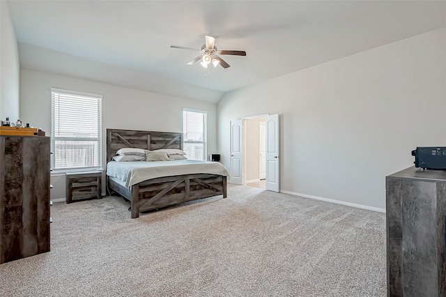 carpeted bedroom with vaulted ceiling and ceiling fan