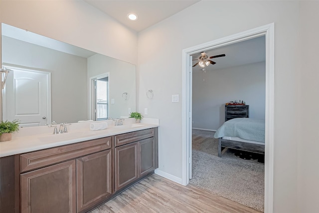 bathroom with ceiling fan, vanity, and hardwood / wood-style floors