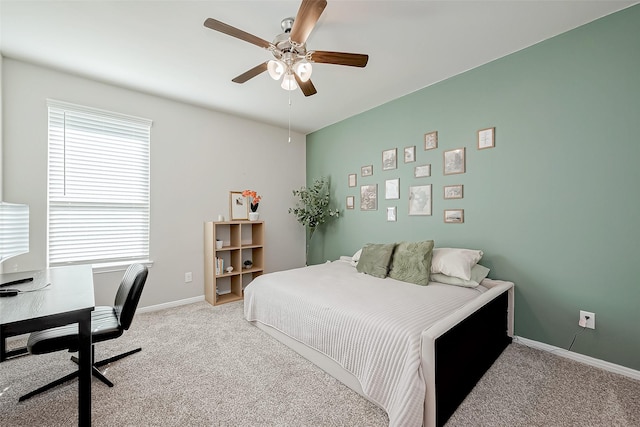 carpeted bedroom featuring multiple windows and ceiling fan