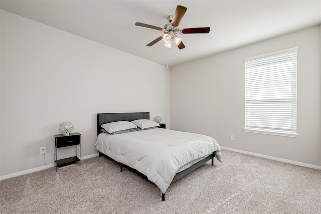 bedroom with multiple windows, ceiling fan, and carpet