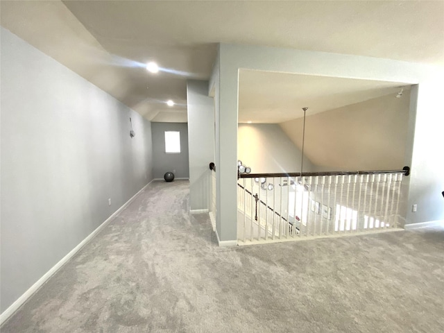 hallway with lofted ceiling and carpet floors