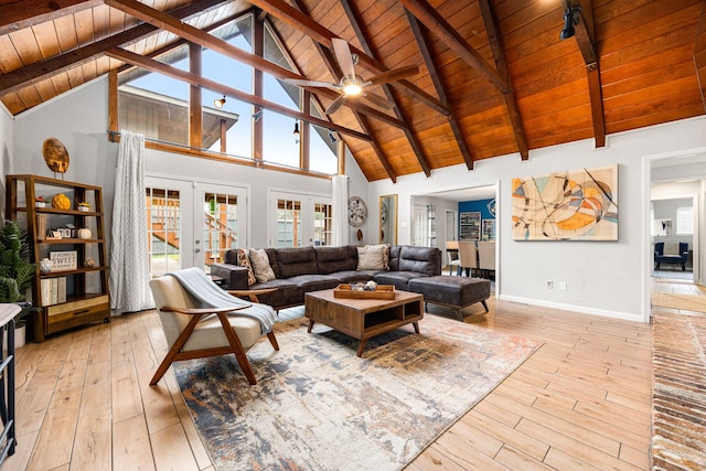 living room with beam ceiling, light hardwood / wood-style flooring, wood ceiling, and french doors