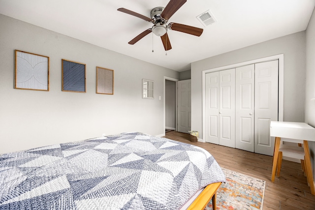 bedroom with ceiling fan, hardwood / wood-style floors, and a closet