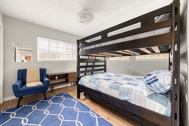 bedroom featuring hardwood / wood-style floors and a textured ceiling