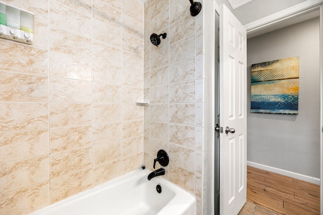 bathroom with wood-type flooring and tiled shower / bath combo