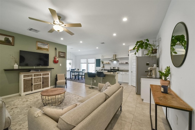 living room featuring light tile patterned floors and ceiling fan