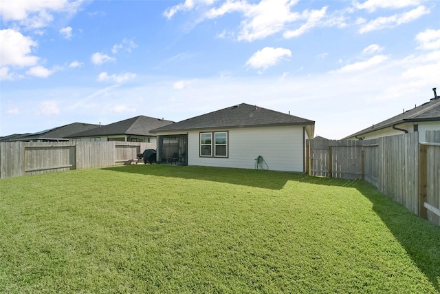 back of house featuring a lawn