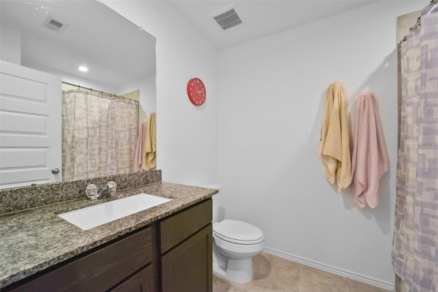 bathroom with vanity, tile patterned floors, and toilet