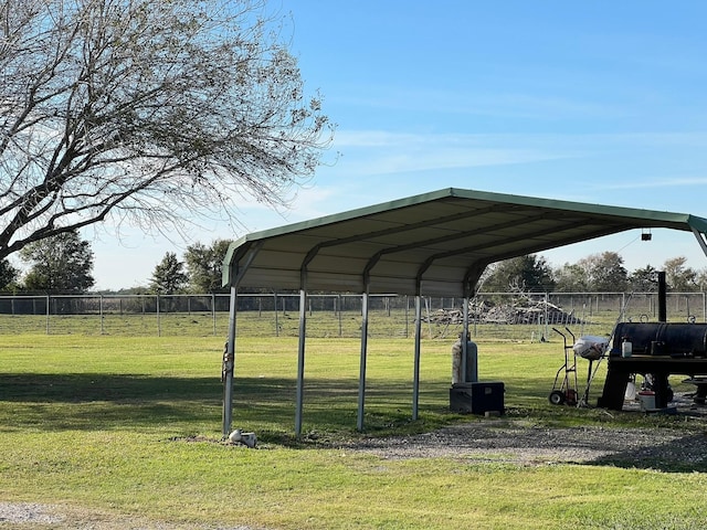 view of parking featuring a carport and a yard