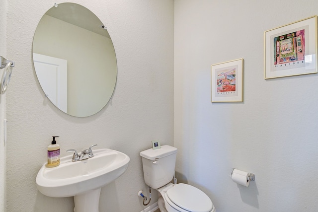 bathroom featuring toilet and sink