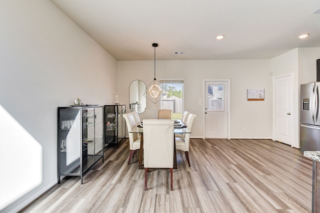 dining room featuring hardwood / wood-style floors and a notable chandelier