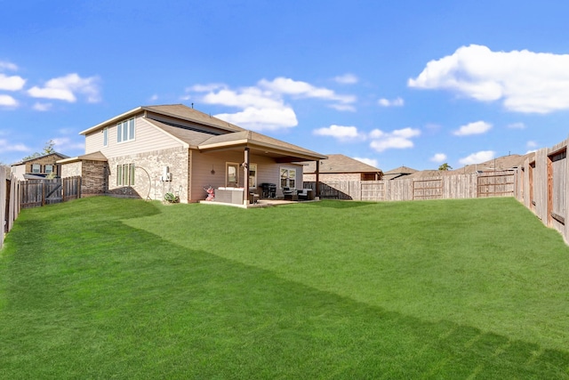 back of house featuring a lawn and a patio area