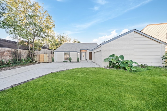 view of front of property with a garage and a front yard