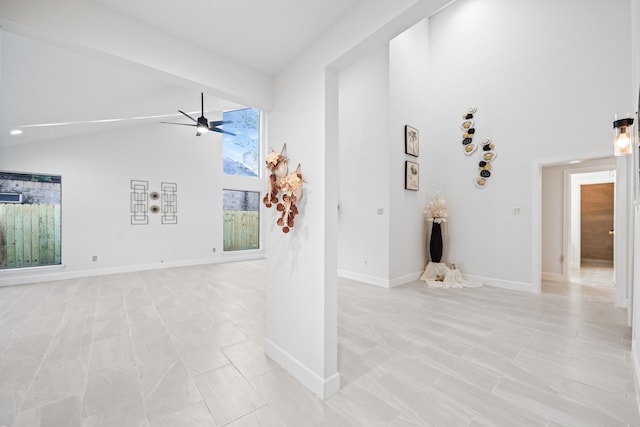 unfurnished living room with lofted ceiling and ceiling fan