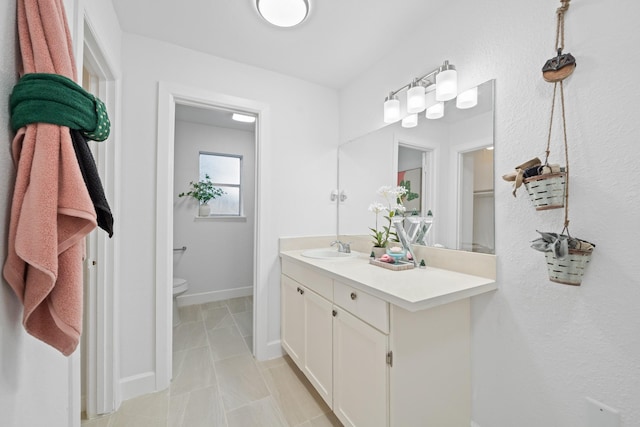 bathroom featuring tile patterned floors, vanity, and toilet