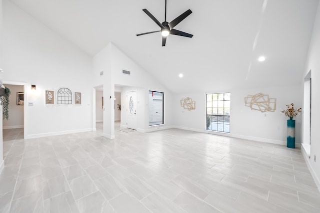 unfurnished living room with ceiling fan and high vaulted ceiling