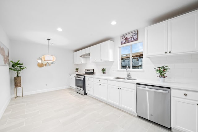 kitchen featuring sink, white cabinetry, tasteful backsplash, decorative light fixtures, and stainless steel appliances