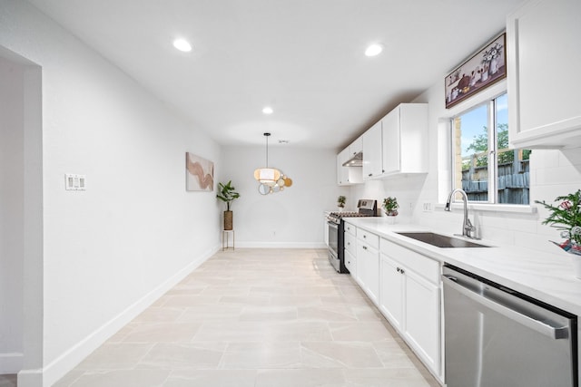 kitchen with stainless steel appliances, white cabinetry, and sink