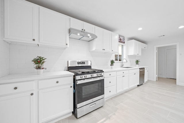 kitchen featuring white cabinetry, sink, backsplash, and stainless steel appliances