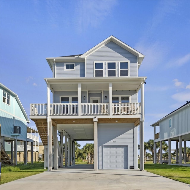 beach home featuring a garage, a carport, and covered porch