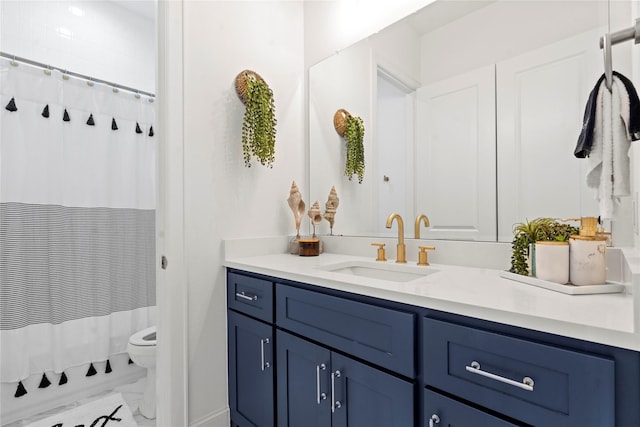 bathroom featuring vanity and toilet