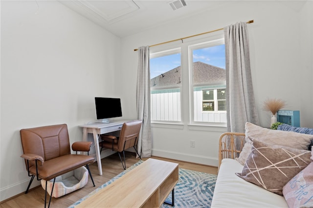 home office with hardwood / wood-style flooring and a healthy amount of sunlight