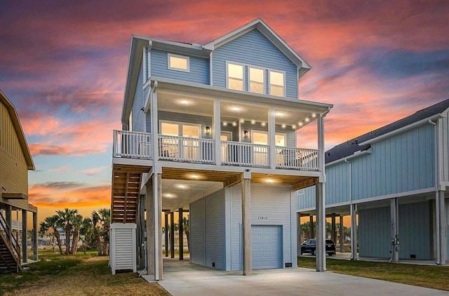 view of front of property featuring a balcony, a garage, and a carport