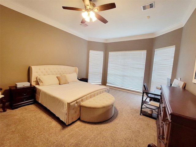 bedroom with ceiling fan, ornamental molding, and light carpet