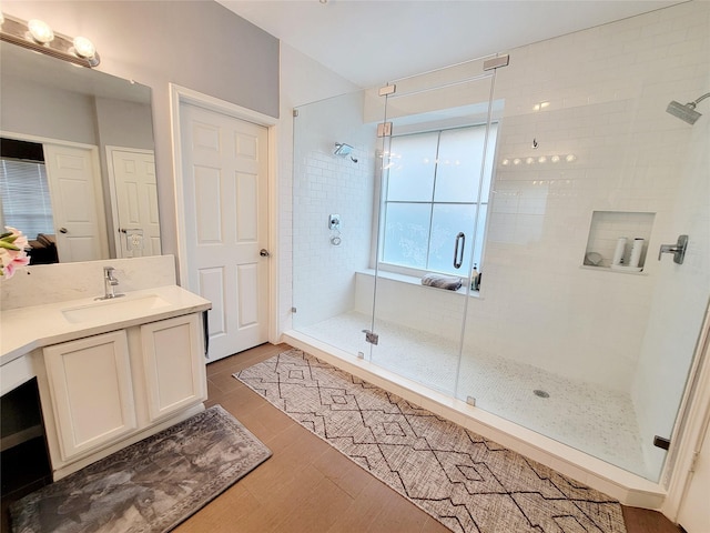 bathroom featuring vanity, hardwood / wood-style floors, and an enclosed shower