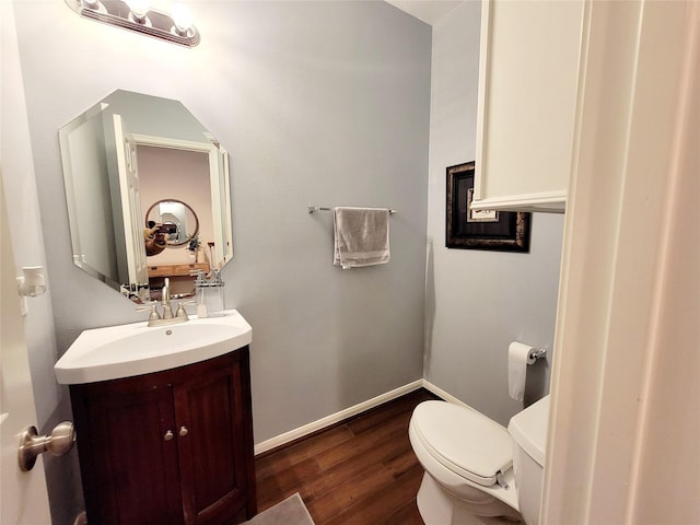 bathroom featuring vanity, hardwood / wood-style flooring, and toilet